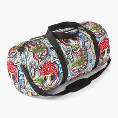 a colorful duffel bag with skulls and mushrooms on the front, sitting against a white background