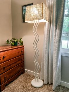 a lamp that is next to a dresser