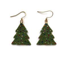 "Handmade Christmas tree earrings using the highest quality Japanese Miyuki Delica 11/0 glass beads in two color variations: matte pine tree green and sparkling various colored beads or a bright green with sparkling various colored beads.  The tree pattern is from Bead and Button magazine.  Over 450 beads are handstitched to create these lightweight and festive earrings. Gold plated ear wire. Approximately 1.25\" long and 1.125\" wide. Each piece is designed by me and handwoven with care and attention to detail which can take several hours to complete.  CUSTOM OPTIONS: If you prefer a different ear wire, please message me for what other options may be available.  SHIPPING: Tasha Jane Designs uses USPS Ground Advantage.  If needed in a quicker timeline, please message me. Shipping charges w Christmas Bead Earrings, Holiday Beaded Jewelry, Christmas Tree Bead, Christmas Tree Beads, Holiday Beading, Handmade Christmas Tree, Tree Earrings, Christmas Tree Earrings, Christmas Bead