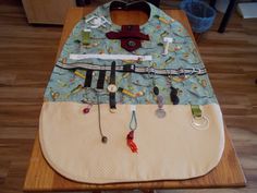 a wooden table topped with a bib on top of it's back end