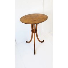 a small wooden table sitting on top of a white floor