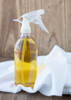 a bottle of cleaner sitting on top of a white cloth