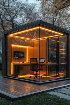 a small office in the middle of a wooden decked area with lights on it