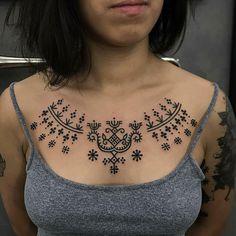 a woman with a tattoo on her chest