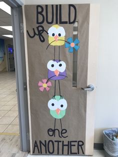 a door decorated with an image of birds and the words build up one another