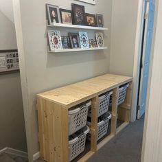 there is a shelf with baskets and pictures on it