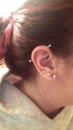 a woman with two piercings on her ear