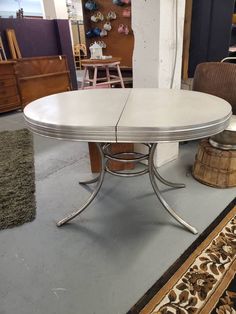 a white table sitting on top of a rug