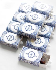 six blue and white candy bars with monogrammed labels on them are lined up in a row