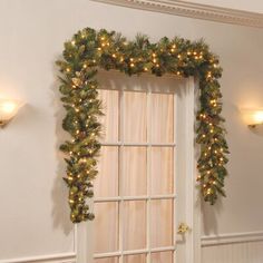 an open door decorated with garland and lights