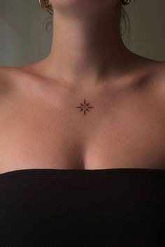 a woman's chest with a small star tattoo on her left shoulder and right breast