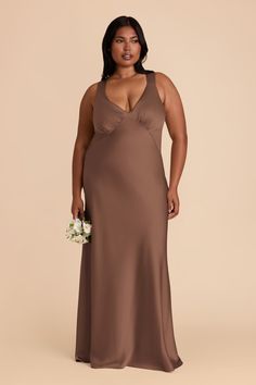 a woman in a long brown dress