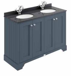 the double sink vanity has two sinks on each side, and is painted dark blue