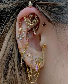 a close up of a person's ear with different types of jewelry on it