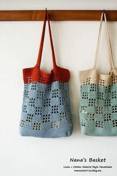 two crocheted bags hanging on a wall