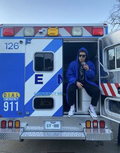 a person sitting in the back of a fire truck