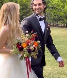 a man in a tuxedo is standing next to a woman wearing a wedding dress