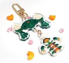 a key chain with an image of a frog and carrots on it, surrounded by candy