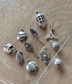 a collection of charms sitting on top of a wooden table