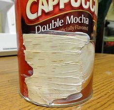 a can of cappucci sitting on top of a wooden table