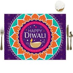 happy diwali placemat with silverware and cupcakes on the side