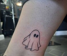 a small ghost tattoo on the ankle