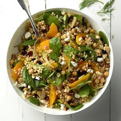 a white bowl filled with vegetables and grains