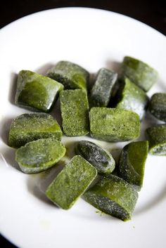 a white plate topped with cut up pieces of pickle sitting on top of a table