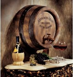 two wooden barrels with wine and cheese on a table