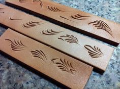 three pieces of carved wood sitting on top of a counter