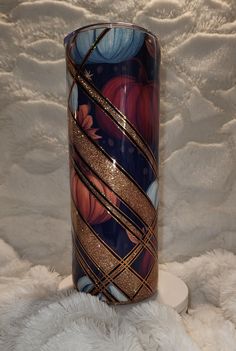 a colorful vase sitting on top of a white blanket