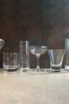 several glasses are lined up on a table