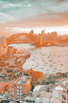 an aerial view of the sydney harbour bridge and opera house, with boats in the water