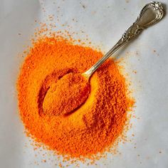 an orange powder with a spoon in it