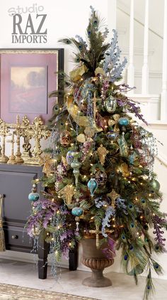 a decorated christmas tree sitting on top of a wooden table next to a stair case