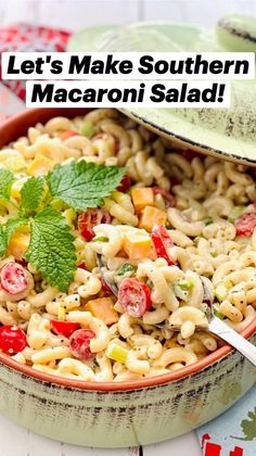 a bowl filled with macaroni salad next to a green pot on top of a table