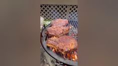 some meat is cooking on an outdoor grill