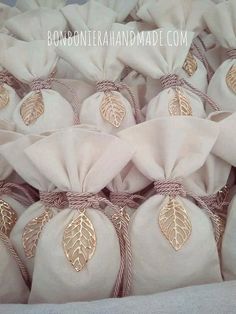 some white bags with gold leaf decorations on them