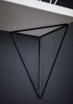 the corner of a wall with a black triangle on it