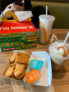 a box of chicken nuggets next to a cup of coffee and milkshake