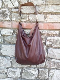 Handmade leather hobo bag make with soft brown leather and brown strong leather. This bag is unlined. Inside there is a big cotton pocket close with zip. Inside there is a leather string with a carabiner for your keys or phone case or for a purse. The bag is closed with a zip. The shoulder belt is made with stronger brown leather. This confortable hobo bag is very practical for any occasion. This bag is very large and soft and may contain many things. Features : - Color brown, - Unlined, - Metal Versatile Brown Hobo Bag With Leather Lining, Brown Leather Lined Satchel Hobo Bag, Brown Leather-lined Satchel Hobo Bag, Elegant Brown Hobo Bag With Zipper Closure, Elegant Brown Hobo Bag, Versatile Brown Hobo Bag With Zipper Closure, Brown Hobo Bag With Removable Pouch, Brown Hobo Shoulder Bag With Zipper Closure, Versatile Brown Leather Hobo Bag