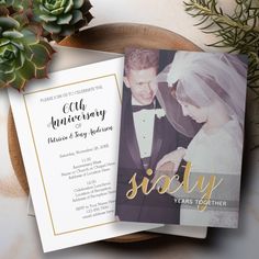 two wedding cards on top of a plate with succulents