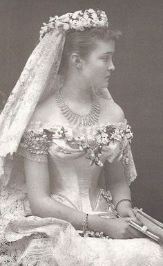 an old photo of a woman wearing a wedding dress