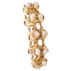 Antique bracelet with natural pearls. This is a beautiful antique bracelet created in America during the turn of the century, back in the 1900. The bracelet has been crafted with mixed styles of Victorian and art & craft in solid yellow gold of 14 and 18 karats with high polished finish. It is composed by ten intricate links-elements which are holding natural gemstones, such: twenty natural pearls, twenty rose cut diamonds and twenty demantoids garnets. The bracelet is fitted with a security pus Victorian Gemstone Bracelets As Gift, Victorian 14k Gold Bracelet, Antique Multi-stone Bracelets For Formal Occasions, Luxury Vintage Pearl Bracelet, Luxury Victorian Gold Collectible Bracelet, Pearls Bracelet, Art Nouveau Pendant, Antique Bracelets, Retro Earring