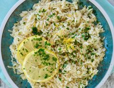 a bowl filled with rice and lemon slices