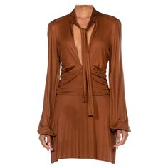 For Sale on 1stDibs - 1990S GUCCI Caramel Brown Rayon Jersey Low Cut Mini Cocktail Dress With Sleeves Gucci Cocktail Dress, Brown Long Sleeve Mini Dress For Evening, Brown V-neck Evening Mini Dress, Brown V-neck Mini Dress For Evening, Evening Brown V-neck Mini Dress, Brown Long Sleeve Mini Dress For Formal Occasions, Brown Dress With Sleeves, Mini Brown Dress, Cocktail Dress With Sleeves