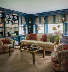 a living room filled with furniture and bookshelves