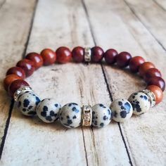 Bracelet Made With 8mm Dalmatian Jasper Stone Beads, Wooden Beads, And Silver Rhinestone Spacer Beads On Elastic Cording. Dalmatian Jasper Jewelry, Knot Jewelry, Jasper Bead Bracelet, Jasper Jewelry, Jewelry Knots, Wood Bracelet, Dalmatian Jasper, Beads Bracelet Design, Jasper Beads