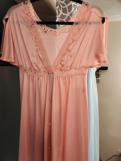 "1970s Vintage Empire Waist Shadowline Dressing Gown/Robe. Size Small, Made in USA, Pink, V Neck, Split short sleeves.  Covered Buttons, Snap at bodice. Bust 32\" Waist 32\" Hips 44\" Length 55\"" Vintage V-neck Sleep Dress, Vintage V-neck Nightgown For Spring, Vintage Pink V-neck Nightgown, Retro Dresses With Lace Trim For Loungewear, Retro Loungewear Dresses With Lace Trim, Spring Vintage V-neck Nightgown, Retro Sleep Dress With Lace Trim, Dressing Gown Robe, Soft Bra