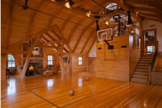 an indoor basketball court with hardwood floors and wooden walls is seen in this image from the inside